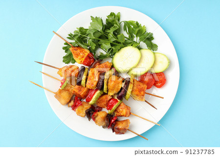 Concept of tasty food with chicken shashlik on blue background 91237785