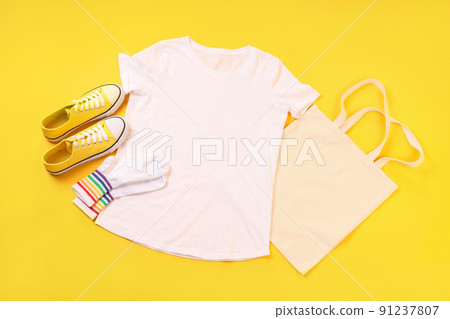 Blank t-shirt, bag, socks and sneakers on yellow background Blank t-shirt, bag, socks and sneakers on yellow background 91237807