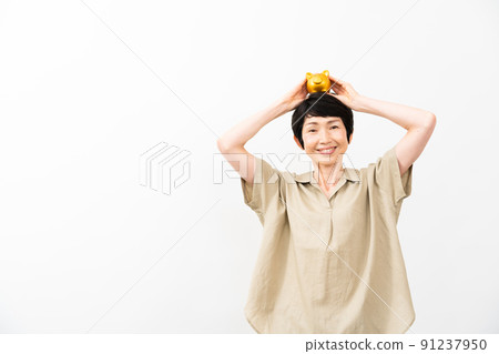 A middle-aged woman with a piggy bank on her head 91237950