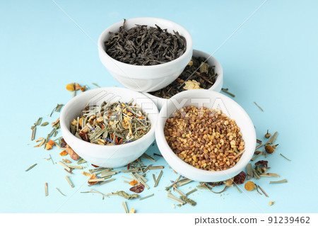 Concept of cooking tea with different types of tea on blue background Concept of cooking tea with different types of tea on blue background 91239462