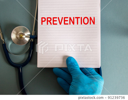 Hand in blue glove, white card with word prevention and stethoscope. Hand in blue glove, white card with word prevention and stethoscope. 91239736