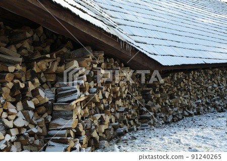 Pile of folded firewood outdoor in winter day 91240265
