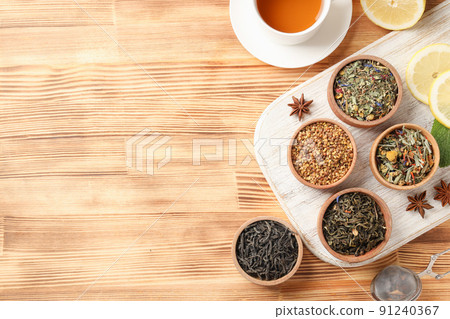 Concept of cooking tea with different types of tea on wooden background 91240367