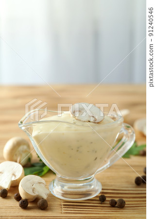 Concept of tasty food with mushroom sauce on wooden table Concept of tasty food with mushroom sauce on wooden table 91240546