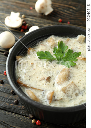 Concept of tasty food with mushroom sauce on wooden background Concept of tasty food with mushroom sauce on wooden background 91240548