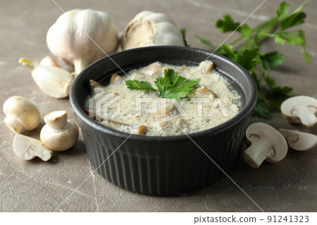 Concept of tasty food with mushroom sauce on gray textured background Concept of tasty food with mushroom sauce on gray textured background 91241323