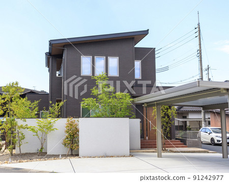 Exterior and sky of a house with a carport 91242977