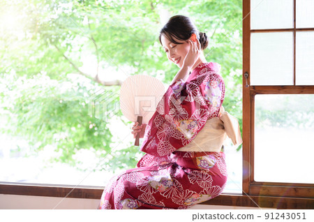 A beautiful woman standing down in a yukata A beautiful woman standing down in a yukata 91243051