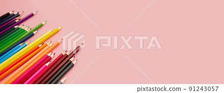 multicolored watercolor pencils on a pink background multicolored watercolor pencils on a pink background 91243057