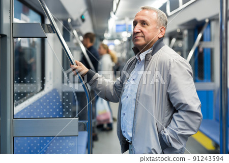 Portrait of senior positive man 60 year old in subway car Portrait of senior positive man 60 year old in subway car 91243594