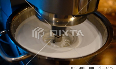 Slow motion 8x Beaten egg cream whites until frothy. Whipped egg whites for a meringue. Red stationary mixer, food processor 91243870