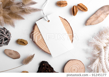 Rectangle white tag mockup on a white background with cotton string and boho decoration, dry plants, element for packing Rectangle white tag mockup on a white background with cotton string and boho decoration, dry plants, element for packing 91245177