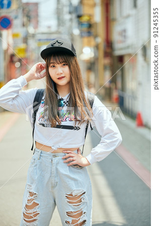 Gen Z women standing looking at the camera 91245355