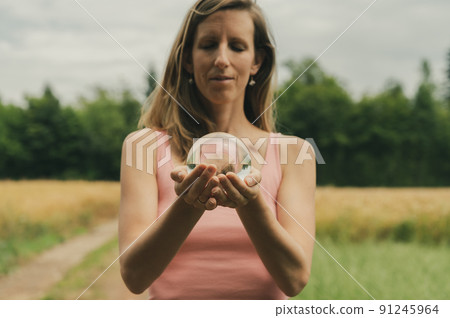 Young woman holding crystal ball Young woman holding crystal ball 91245964