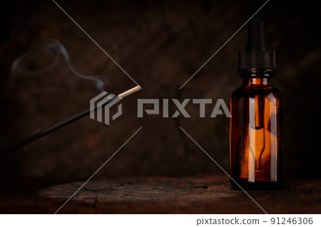 Old wooden background with free space for decoration and dark incense smoke background. Mock-up for oil relax. Old wooden background with free space for decoration and dark incense smoke background. Mock-up for oil relax. 91246306