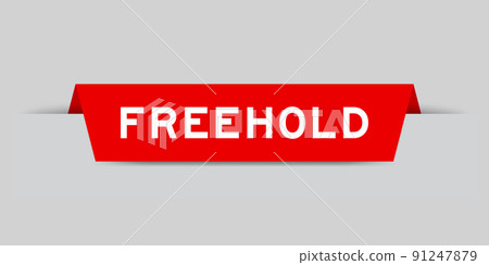 Red color inserted label with word freehold on gray background 91247879