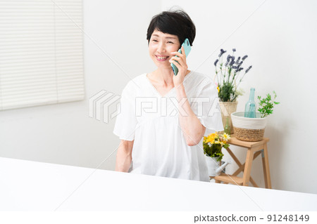 Middle woman making a call on a smartphone Middle woman making a call on a smartphone 91248149