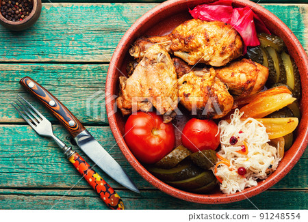 Baked chicken and pickles. 91248554