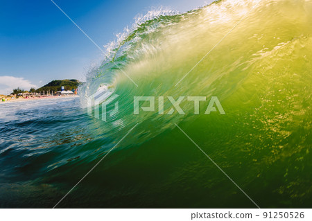 Perfect wave breaking in ocean with warm sun light. 91250526
