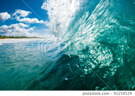 Beachbreak waves in ocean. Breaking barrel wave with sunshine Beachbreak waves in ocean. Breaking barrel wave with sunshine 91250529