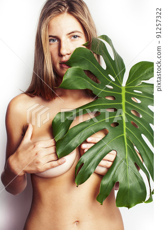 young pretty blond girl naked posing isolated on white background with big green leaf, lifestyle people concept close up young pretty blond girl naked posing isolated on white background with big green leaf, lifestyle people concept close up 91257322