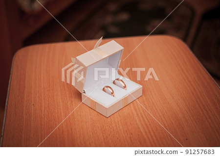 Gold wedding rings in the white box Gold wedding rings in the white box 91257683