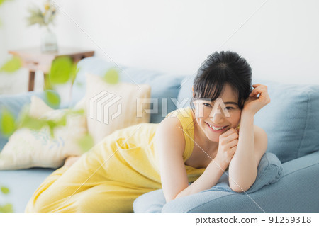 A woman relaxing on the sofa A woman relaxing on the sofa 91259318