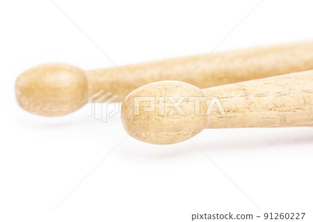 Two wooden drumsticks lying, isolated on a white background Two wooden drumsticks lying, isolated on a white background 91260227