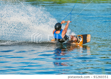 Kiteboarder enjoy surfing on the lake surface. Kiteboarder enjoy surfing on the lake surface. 91260351