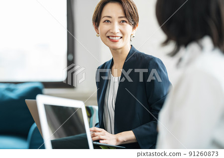 Career woman working in a coworking space Career woman working in a coworking space 91260873