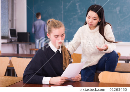 Girls university students sitting at desk and preparing for exams 91263460