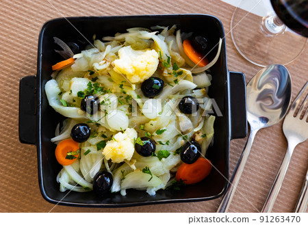 Portuguese cod salad with pickled vegetables, olives and greens Portuguese cod salad with pickled vegetables, olives and greens 91263470