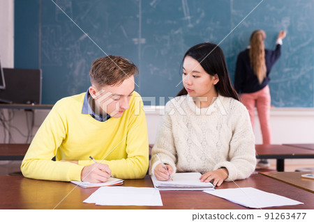 Two students studying together in schoolroom Two students studying together in schoolroom 91263477