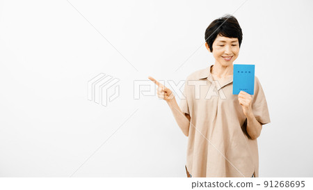 Middle woman pointing with a pension book Middle woman pointing with a pension book 91268695