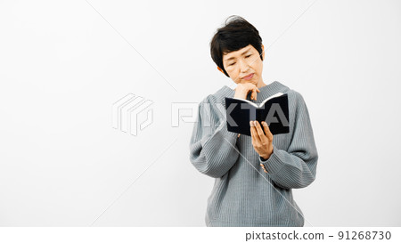 Middle aged woman reading a book Middle aged woman reading a book 91268730