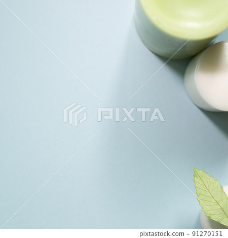 Candle and green leaf on blue background. top view, copy space Candle and green leaf on blue background. top view, copy space 91270151