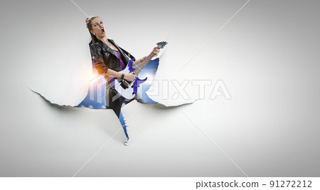 Young and beautiful rock girl playing the electric guitar Young and beautiful rock girl playing the electric guitar 91272212