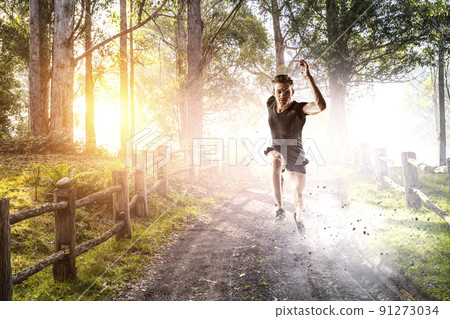 Man in sportwear running . Mixed media 91273034