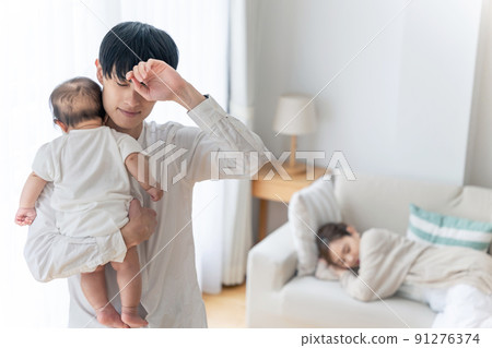 A man who is worried about holding a baby, tired of childcare, postpartum depression A man who is worried about holding a baby, tired of childcare, postpartum depression 91276374