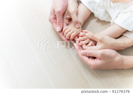 Baby holding hands and family Family image 91276376