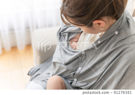 Women breastfeeding with a nursing cover 91276381