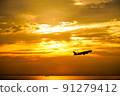An airplane taking off toward the evening sky 91279412