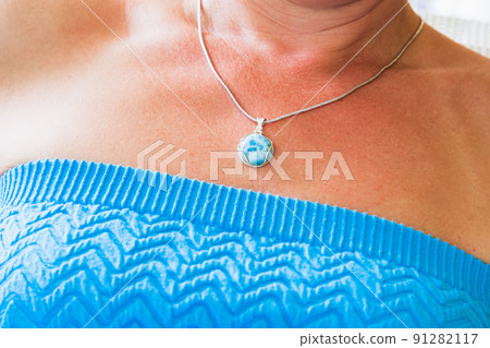 Silver necklace with round larimar stone, close up Silver necklace with round larimar stone, close up 91282117