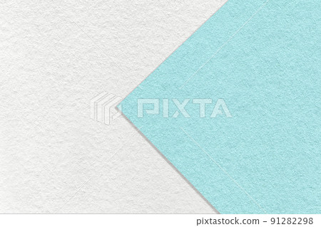 Texture of white and light blue paper background, half two colors with arrow, macro. Structure of turquoise cardboard. Texture of white and light blue paper background, half two colors with arrow, macro. Structure of turquoise cardboard. 91282298