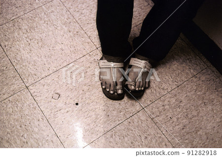 Ethnic sandals on tile floor 91282918