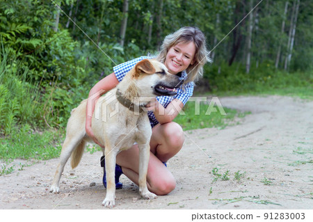 Beautiful yong woman is cuddling dog expressing animal love Beautiful yong woman is cuddling dog expressing animal love 91283003