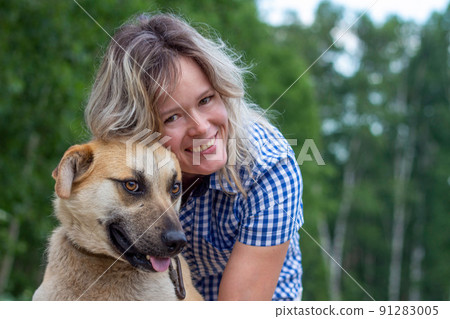 Beautiful yong woman is cuddling dog expressing animal love Beautiful yong woman is cuddling dog expressing animal love 91283005