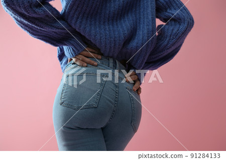 Woman wearing jeans on pink background, closeup Woman wearing jeans on pink background, closeup 91284133