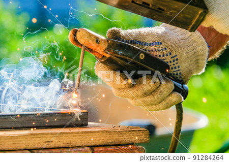 Sparks and smoke from metal arc welding. 91284264