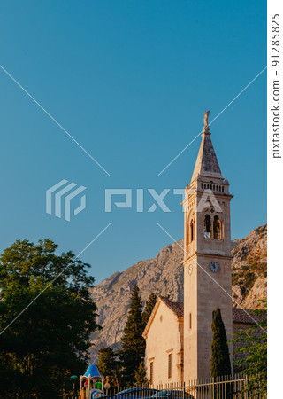 Beautiful Sunset view of the coast of Kotor Bay and St.Eustace's Church in the village Dobrota in Montenegro. Church of St. Eustachius is located in Dobrota , Kotor Montenegro. Beautiful Sunset view of the coast of Kotor Bay and St.Eustace's Church in the village Dobrota in Montenegro. Church of St. Eustachius is located in Dobrota , Kotor Montenegro. 91285825